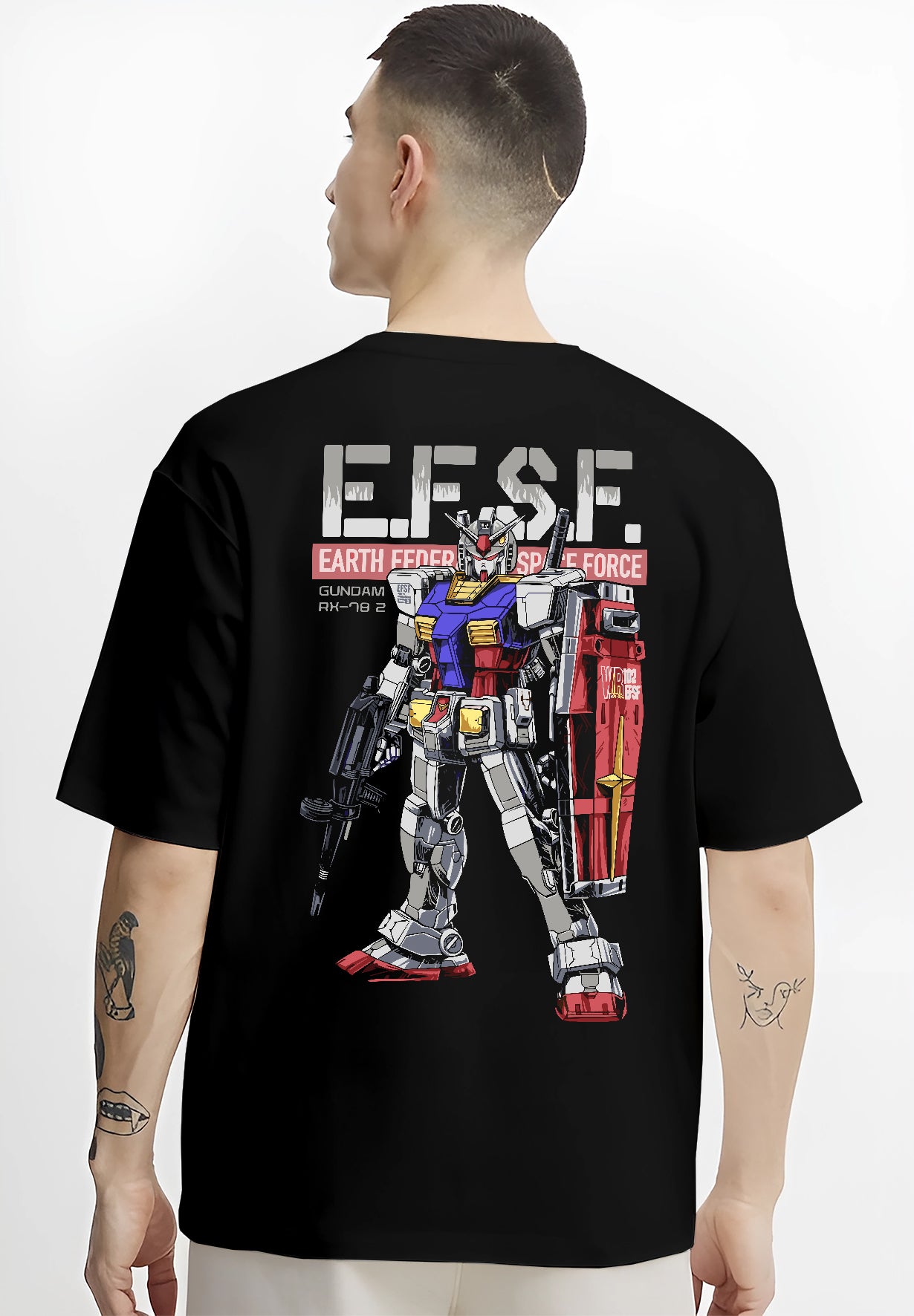Black T-shirt on male model, back view, featuring Gundam RX-78-2 retro mecha graphic with bold EFSF type, shield, and rifle.