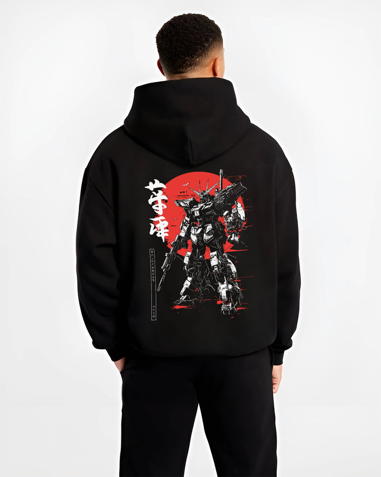 Black hoodie worn by a male model, back view, featuring Gundam Japanese animation streetwear artwork with retro mecha design against a vivid red sun accent.