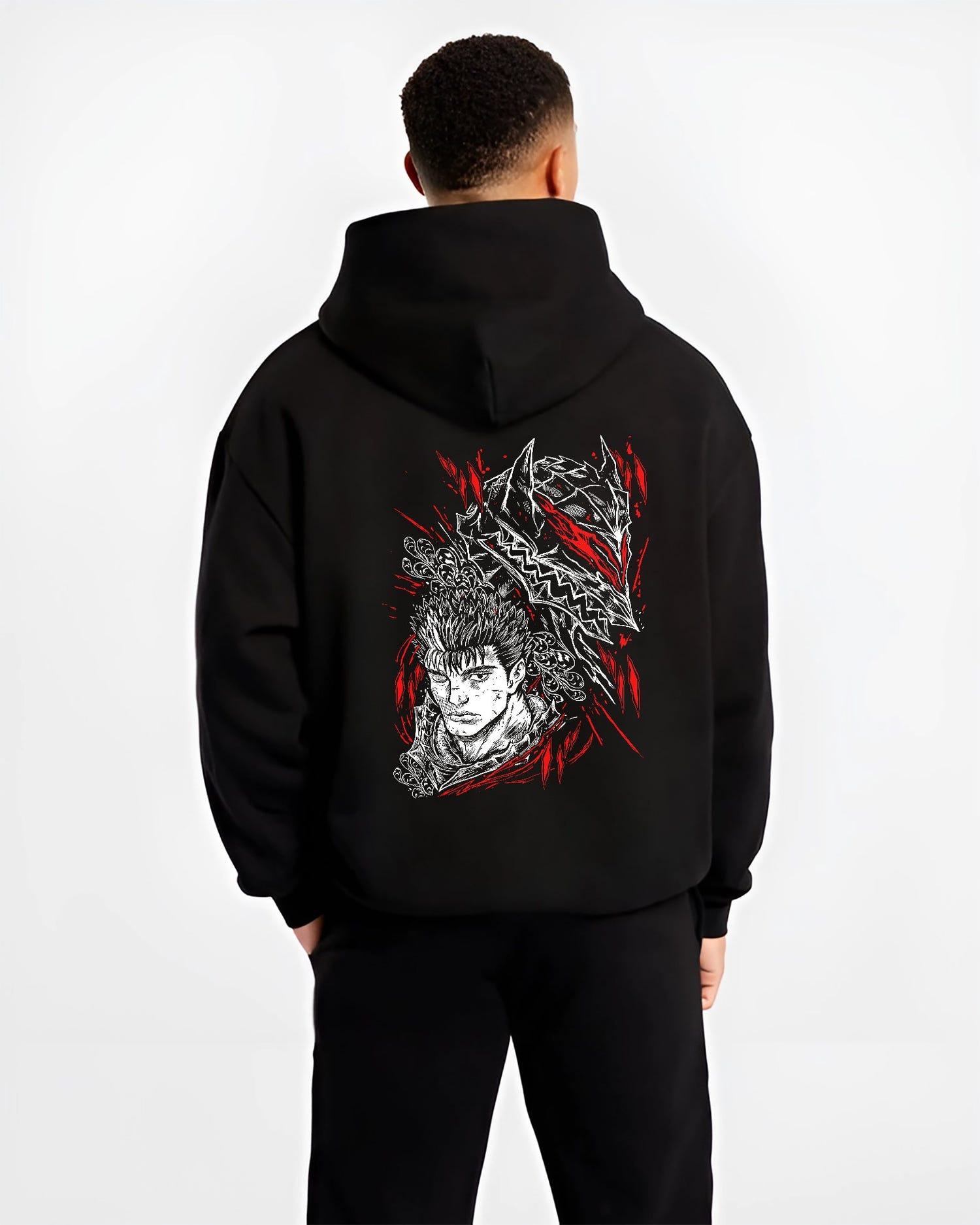 Black hoodie worn by a male model, back view, featuring Guts Berserk retro manga graphic with shonen battle character and dark fantasy-inspired artwork.