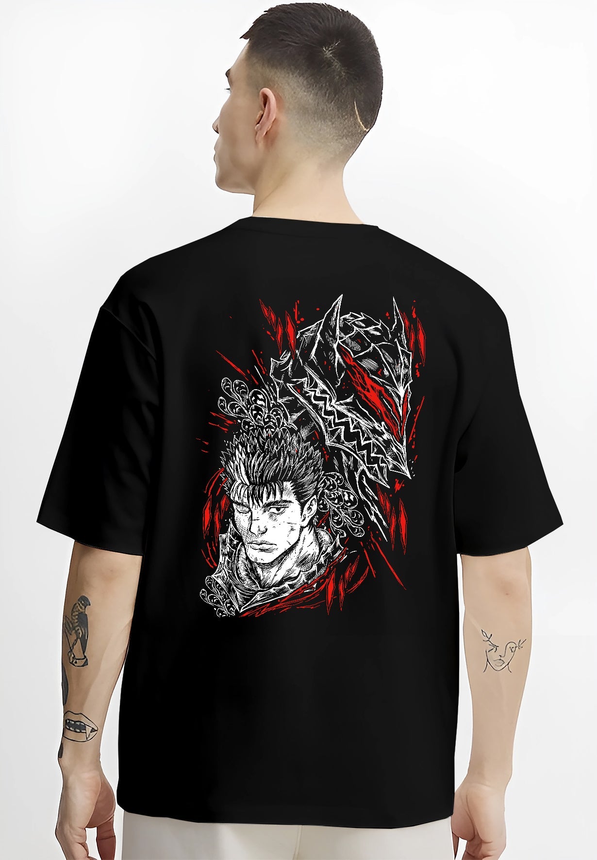Black T-shirt worn by a male model, back view, featuring Guts Berserk anime poster inspired artwork in dark manga style with red battle aura.