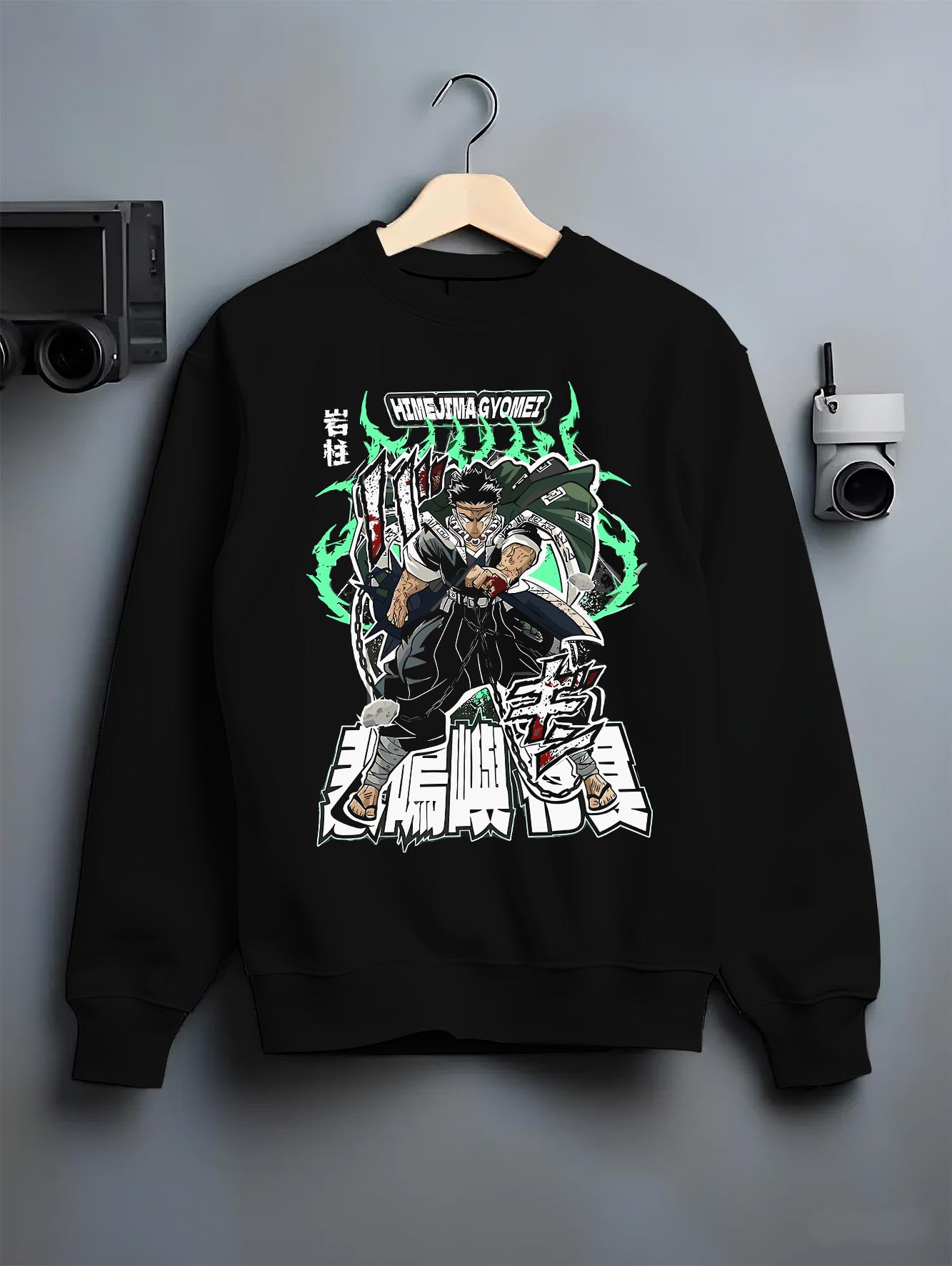 Black crewneck sweatshirt on a hanger against a grey wall, featuring Himejima Demon Slayer retro streetwear graphic with shonen battle character and glowing manga aura.