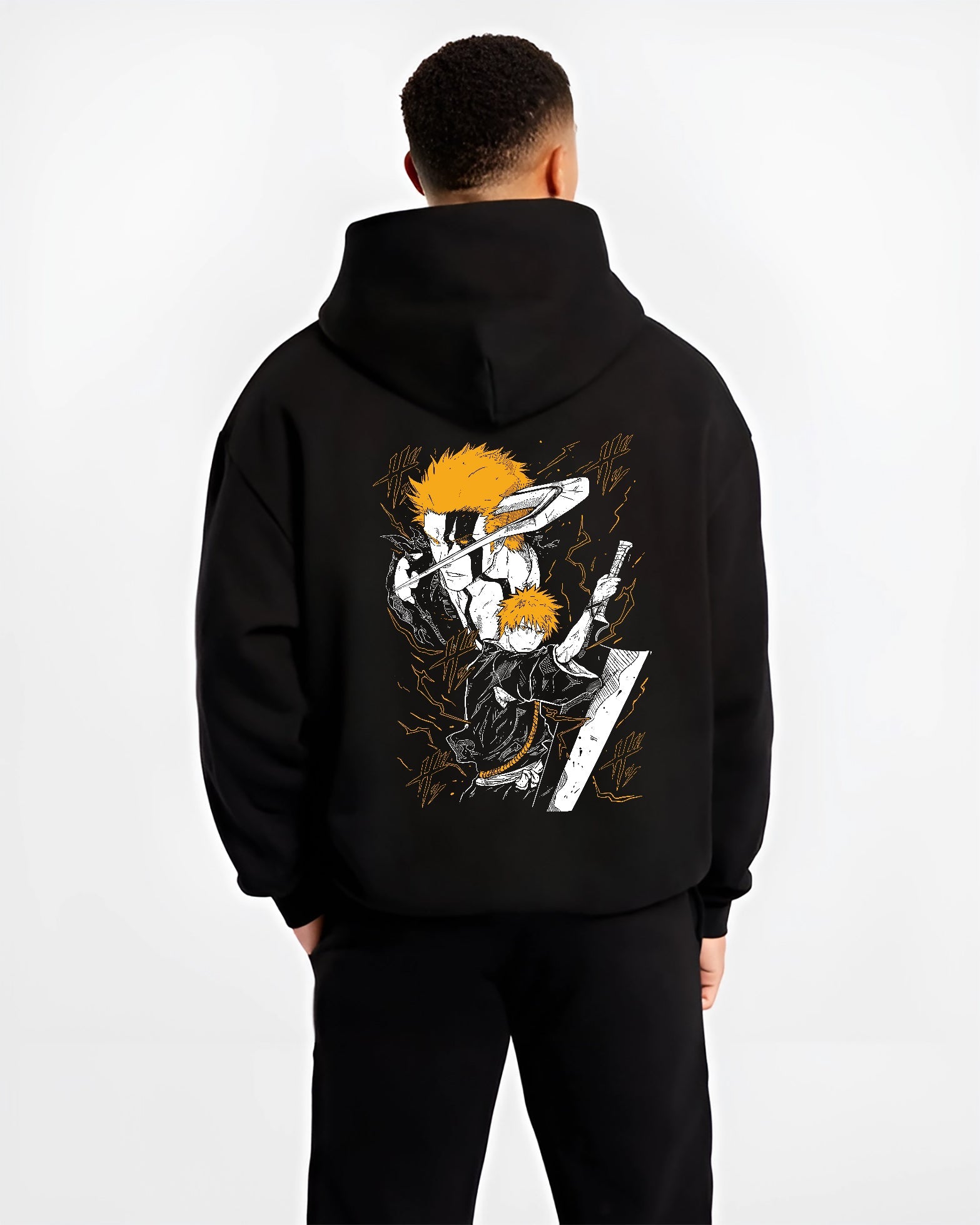 Black hoodie worn by a male model, back view, featuring Ichigo Bleach Japanese animation streetwear graphic with shonen battle character in striking orange sword pose.