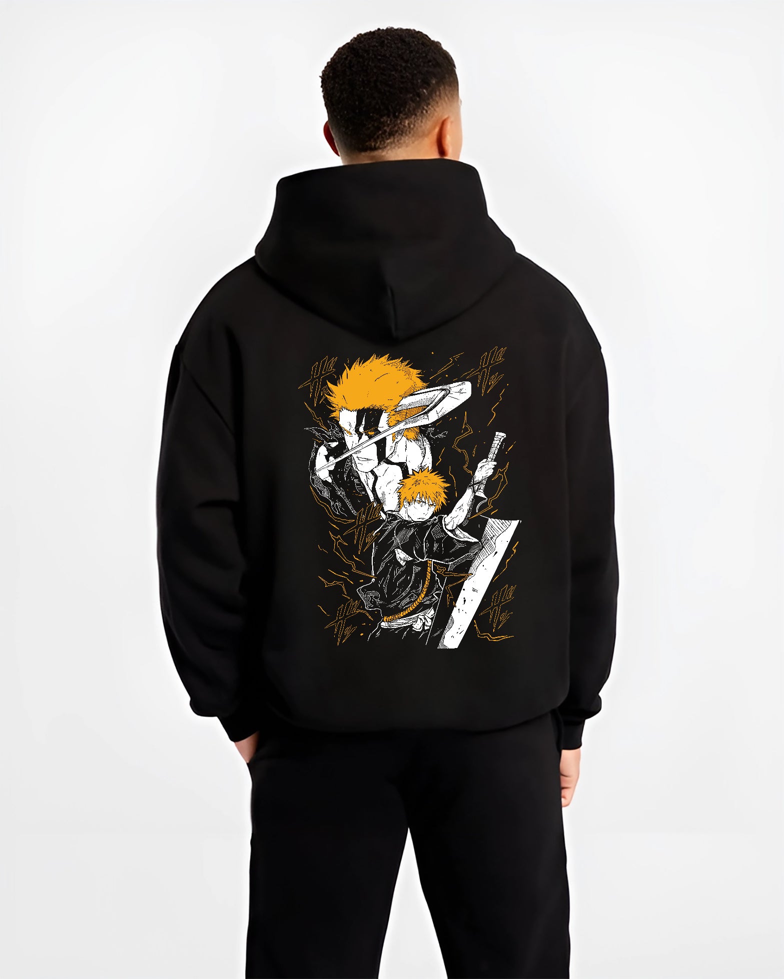 Black hoodie worn by a male model, back view, featuring Ichigo Bleach Japanese animation streetwear graphic with shonen battle character in striking orange sword pose.