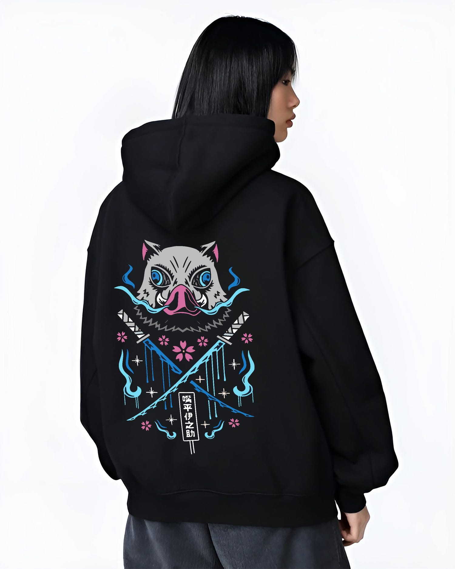 Black hoodie on female model, back view, Inosuke Demon Slayer design with crossed blades, blue spirit flames, and pink cherry blossoms.