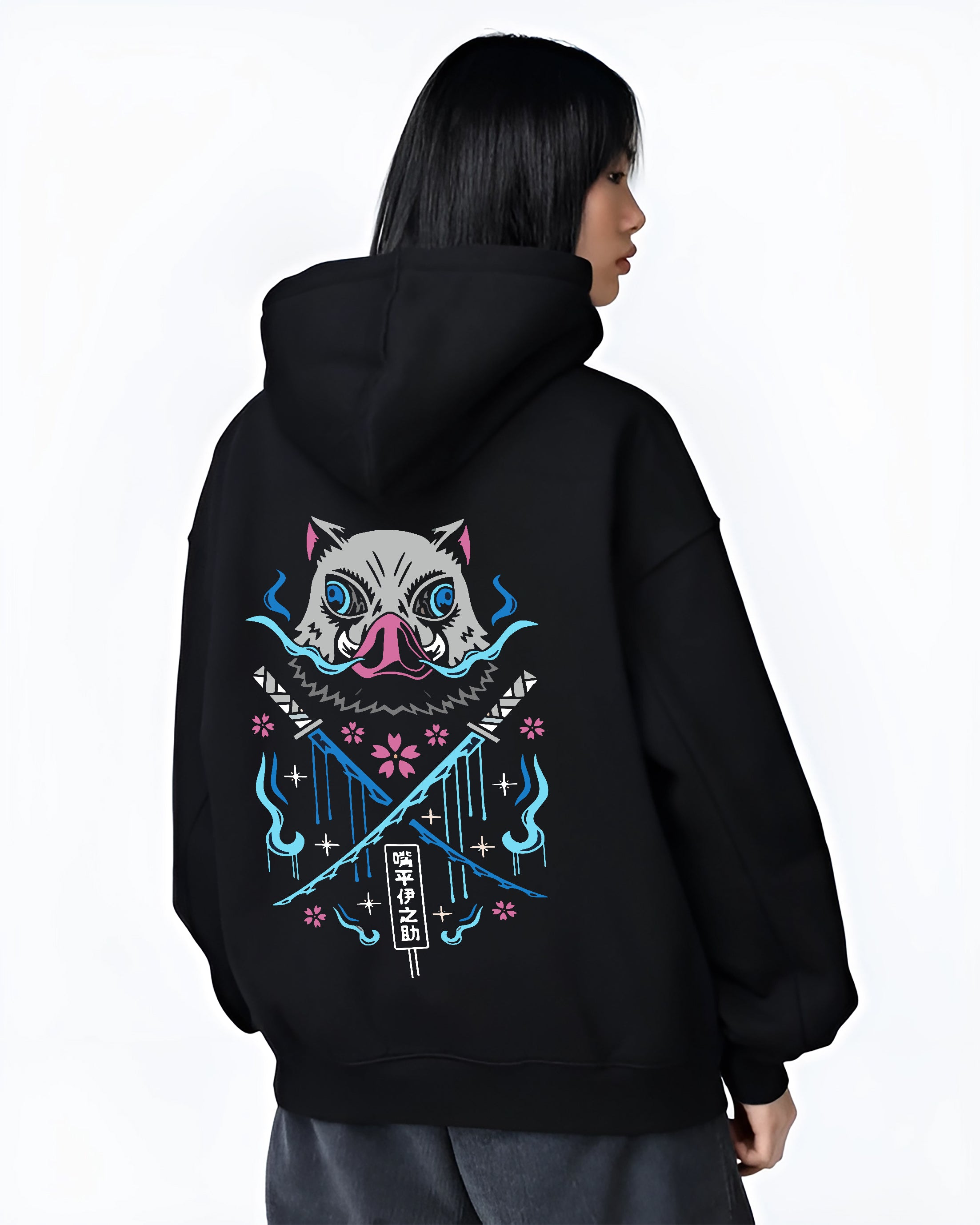 Black hoodie on female model, back view, Inosuke Demon Slayer design with crossed blades, blue spirit flames, and pink cherry blossoms.
