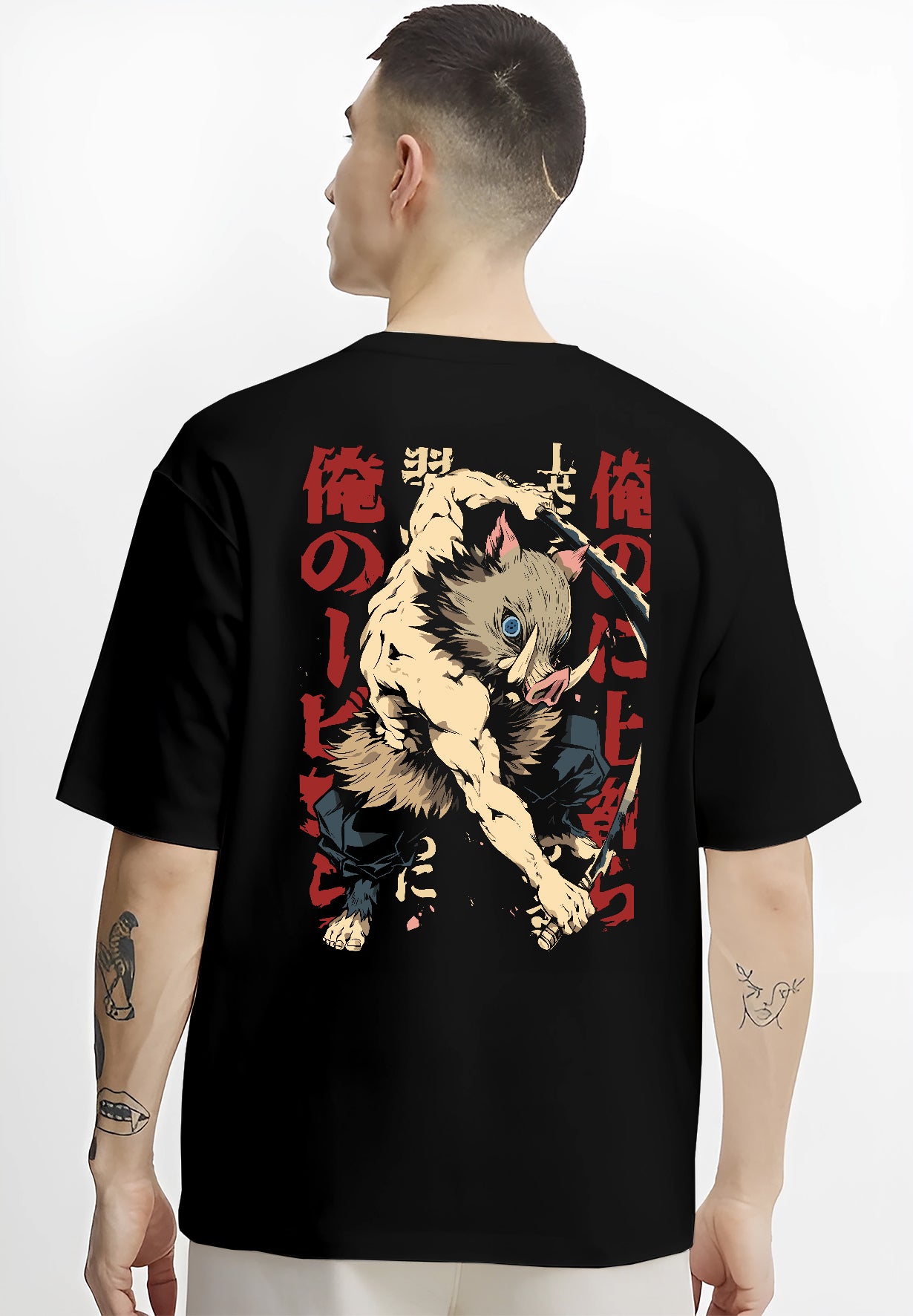 Black T-shirt worn by a male model, back view, featuring Inosuke Demon Slayer shonen battle character artwork with dual swords and retro manga streetwear design.