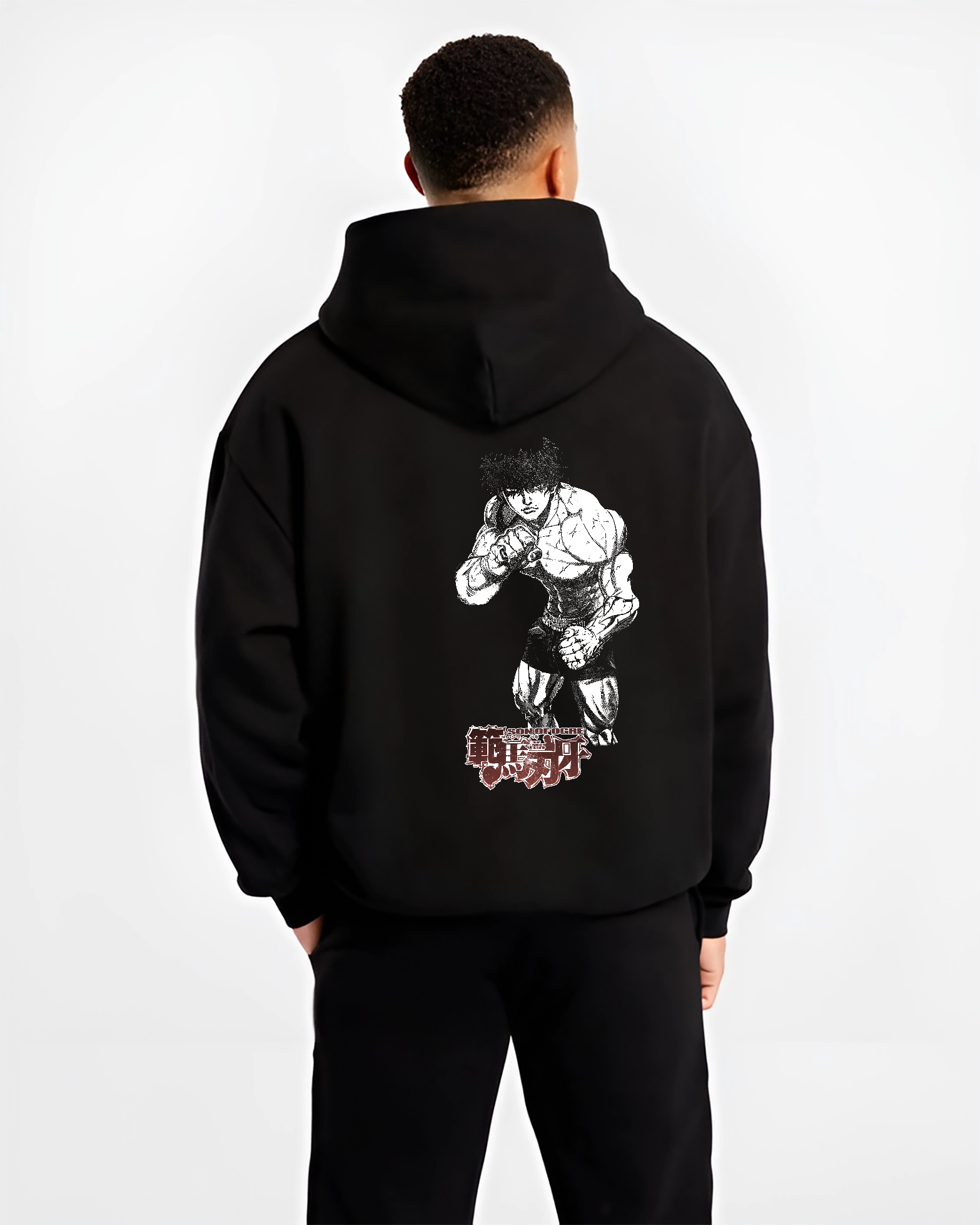 Black hoodie worn by a male model, back view, featuring Baki Hanma Son of Ogre shonen battle inspired anime design with retro manga artwork details.