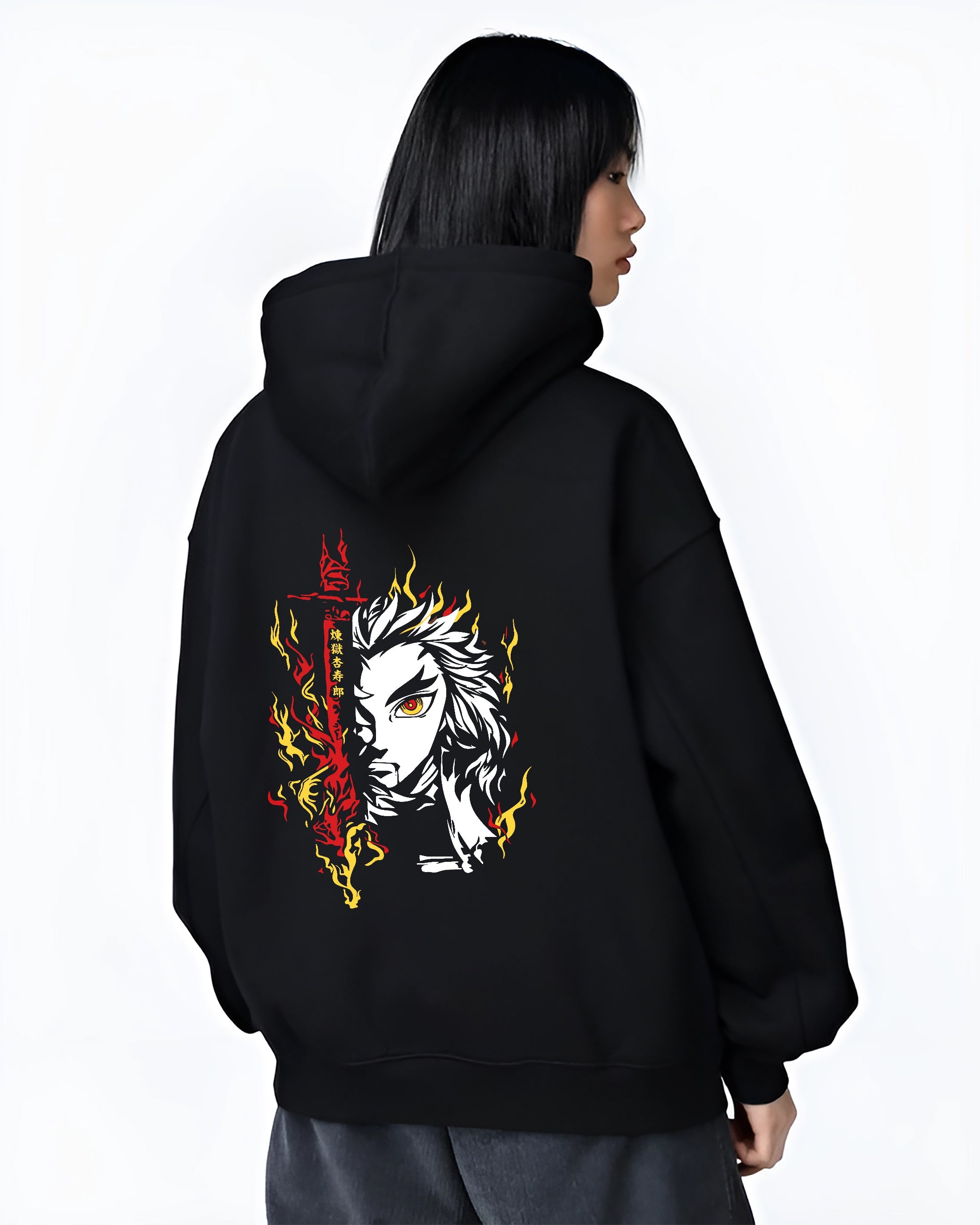 Black hoodie on female model, back view, featuring Rengoku retro manga graphic with fiery sword aura and bold yellow-red flames.