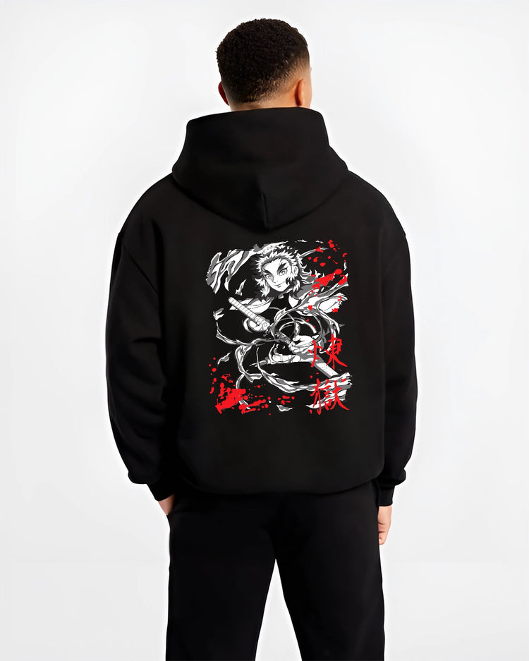 Black hoodie worn by a male model, back view, featuring Rengoku Demon Slayer anime poster style flames with dynamic urban streetwear graphic.