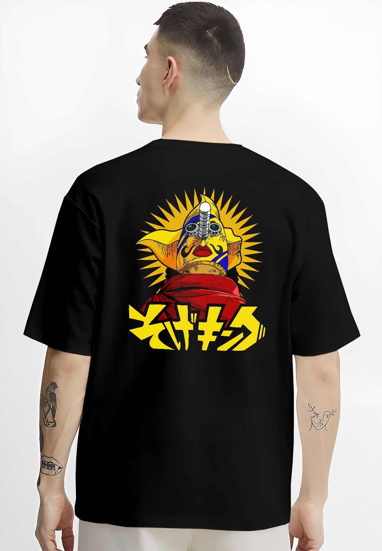 Black T-shirt on male model, back view, featuring Japanese animation streetwear graphic of a masked idol, sunburst background, and kanji.