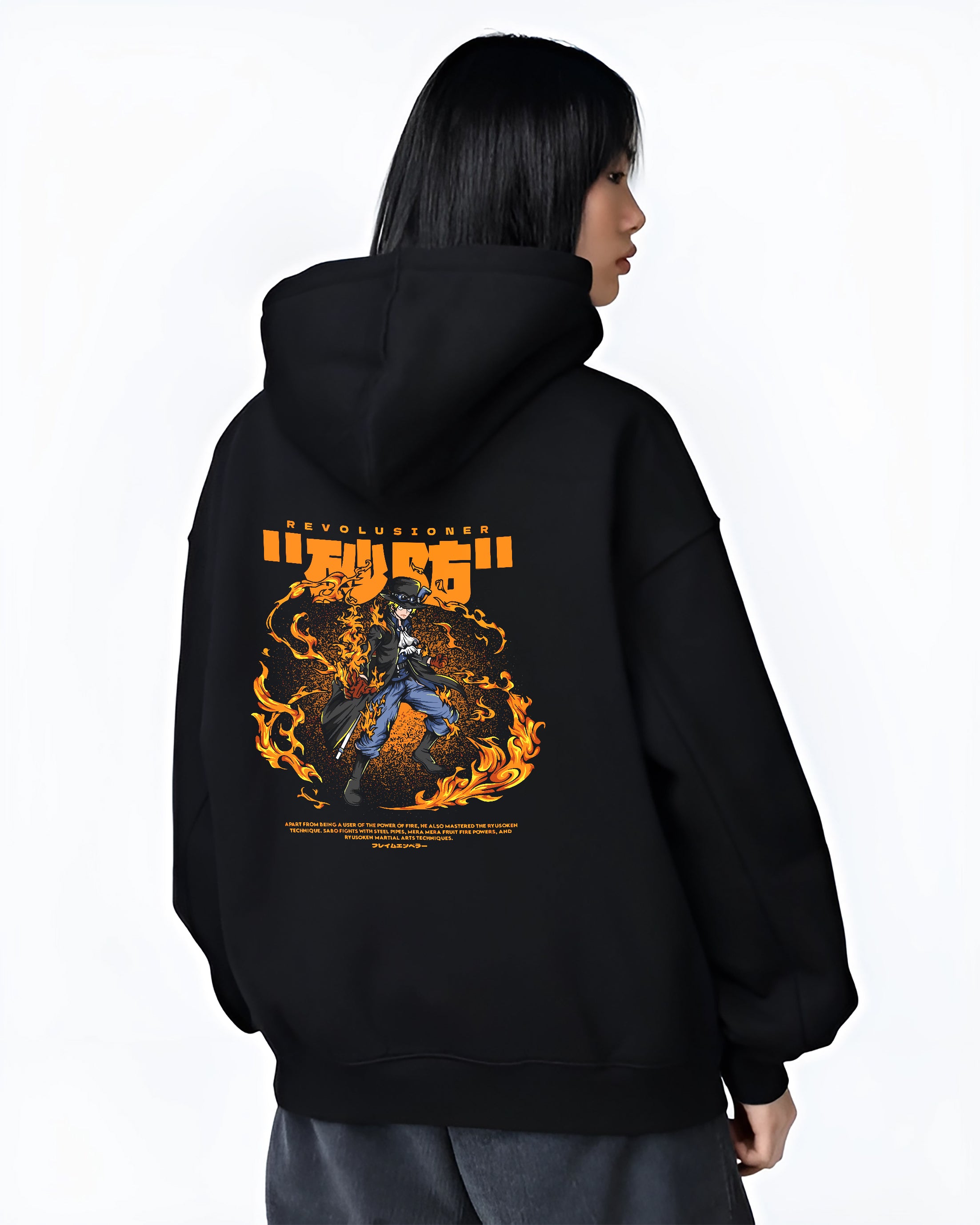 Black hoodie worn by a female model, back view, featuring Sabo One Piece fiery battle anime poster inspired design with orange flame retro manga graphic