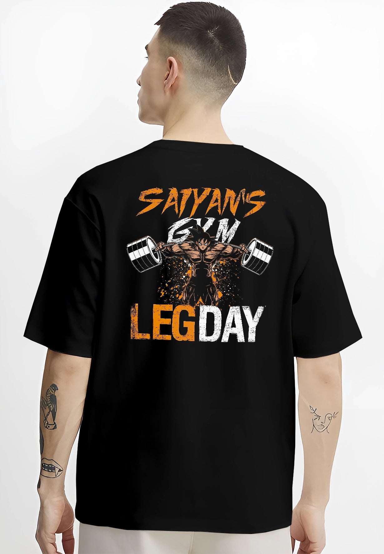 Black T-shirt worn by a male model, back view, featuring Saiyan’s Gym Leg Day retro manga poster design with anime-inspired muscular figure in battle stance.