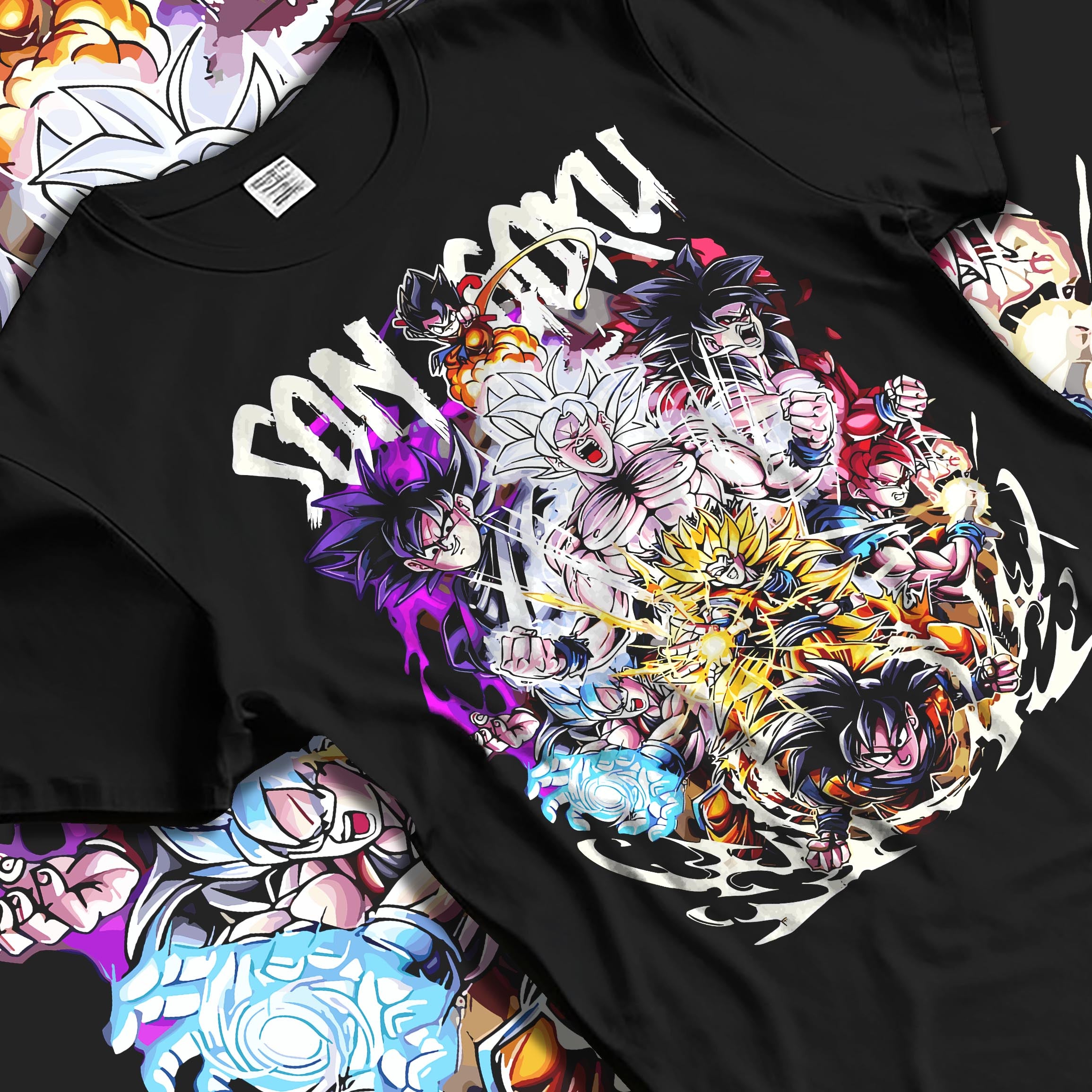 Black T-shirt laid flat with natural fabric folds, featuring Son Goku Dragon Ball shonen battle character artwork with layered transformations in a retro anime style.