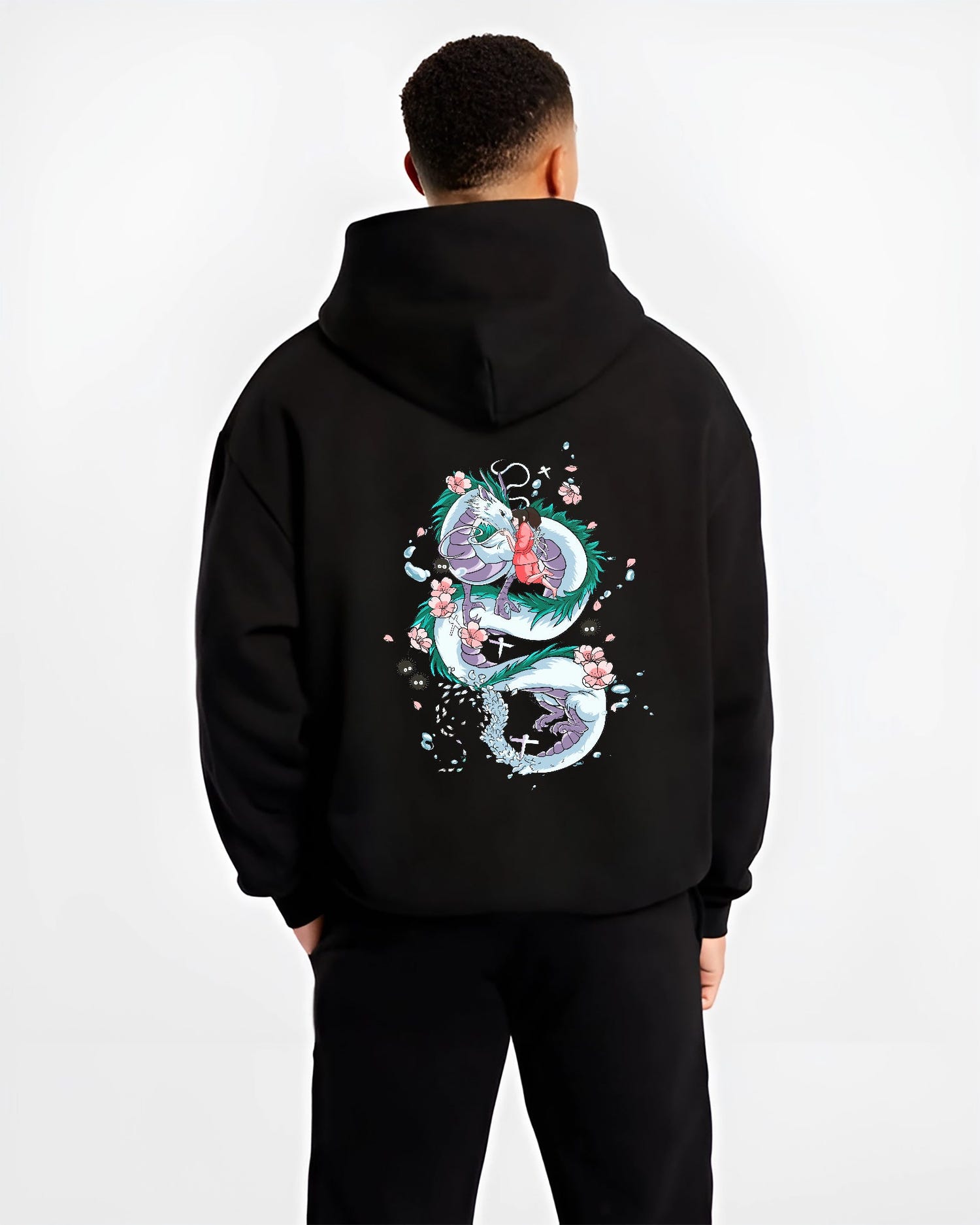 Black hoodie on male model, back view, Spirited Away Haku dragon coiled around Chihiro anime poster graphic with blossom details.