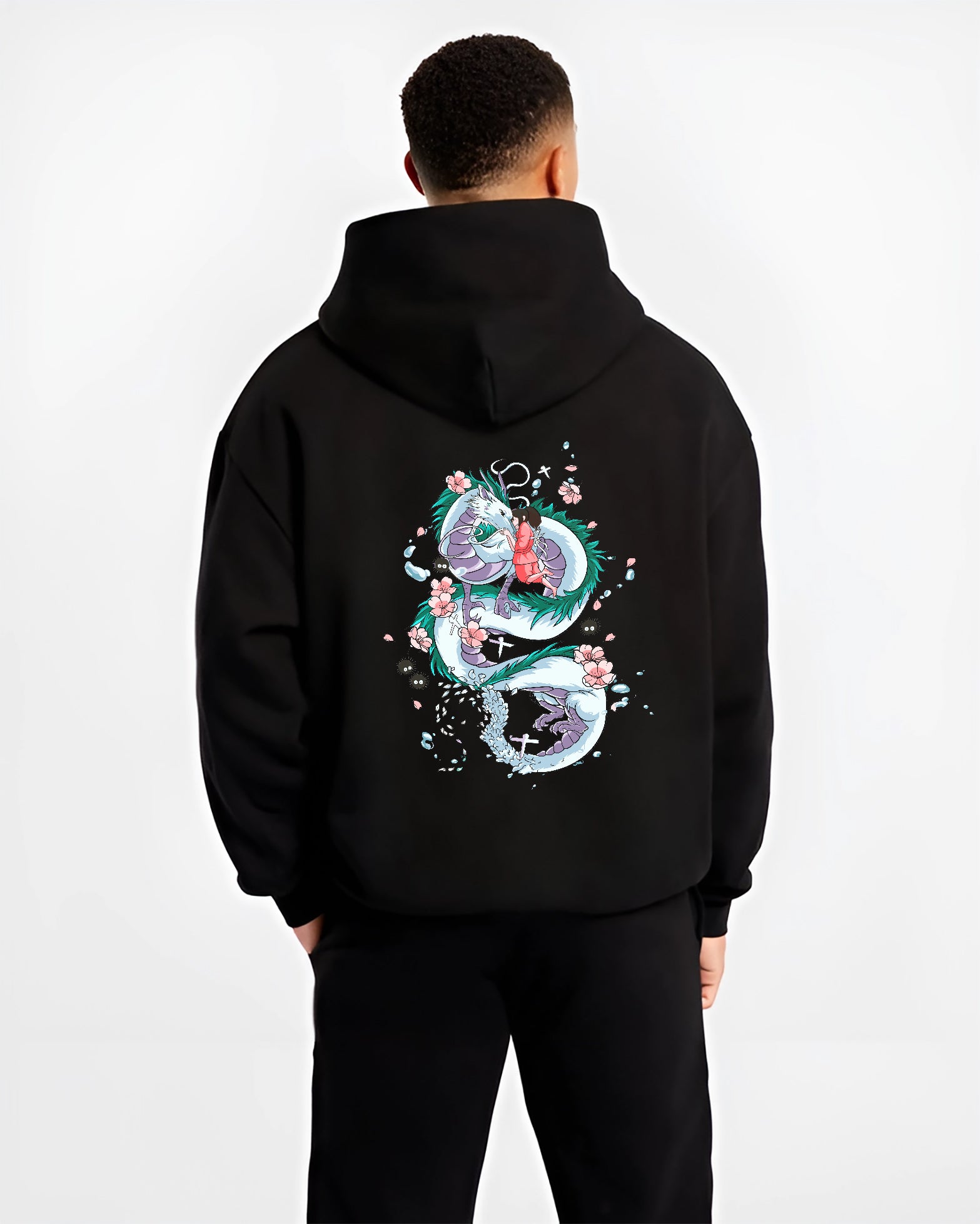 Black hoodie on male model, back view, Spirited Away Haku dragon coiled around Chihiro anime poster graphic with blossom details.
