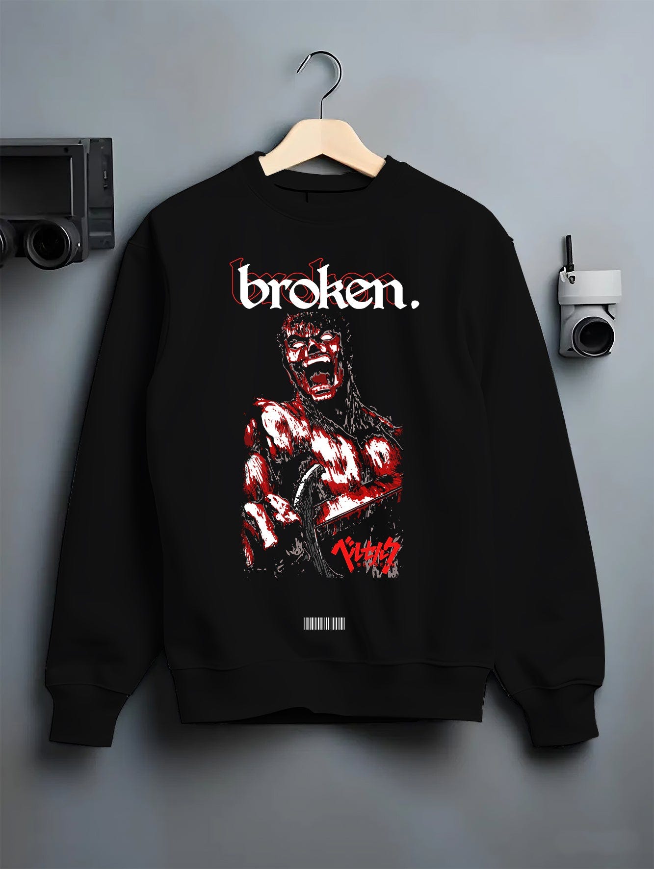 Black crewneck sweatshirt on a hanger against a grey wall, featuring Berserk Guts dark manga panel inspired design with blood-red retro streetwear artwork style.