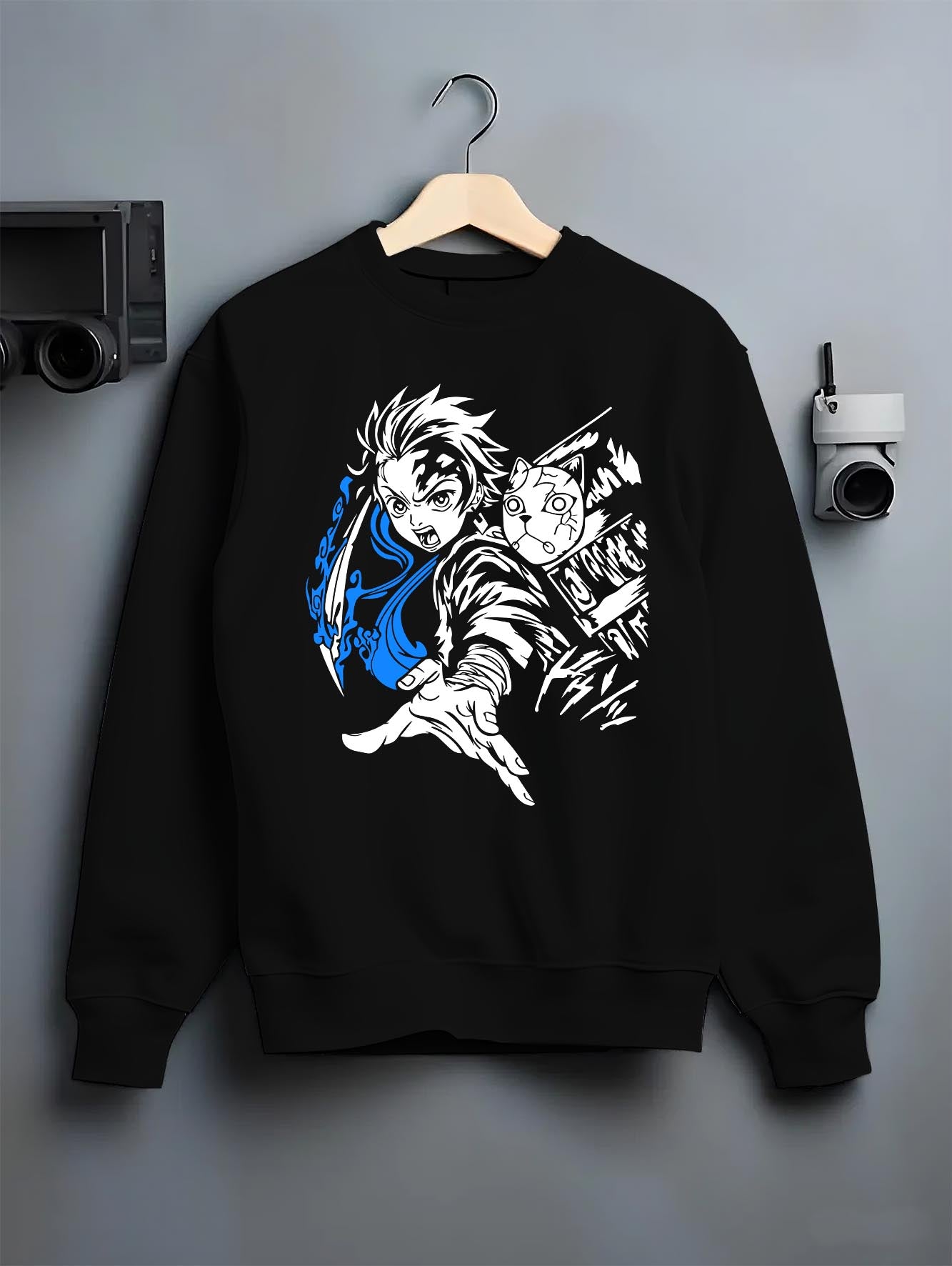 Black crewneck sweatshirt on hanger against grey wall, featuring Tanjiro fox mask graphic with flowing blue water slash, retro manga style.