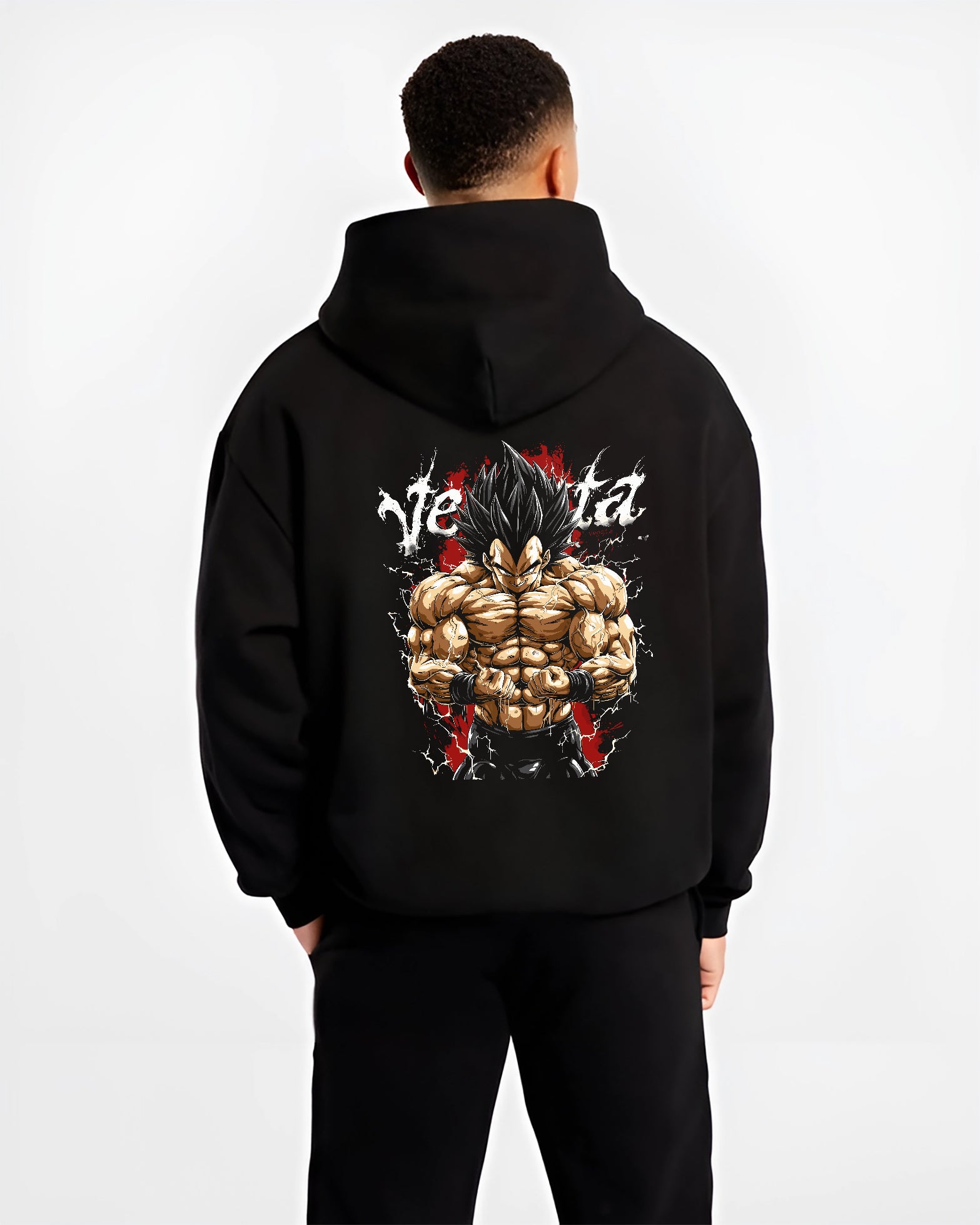 Black hoodie worn by a male model, back view, featuring Vegeta Dragon Ball Z retro manga graphic with bold shonen character art in powerful battle stance.